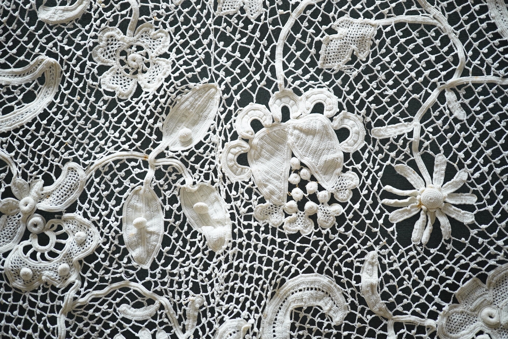 A fancy crochet and anglaise hand worked tablecloth, together with a collection of lawn and linen table linen, mats, etc. and various lengths of lace including a panel of Irish crochet, Irish crochet panel 142cm long x 5